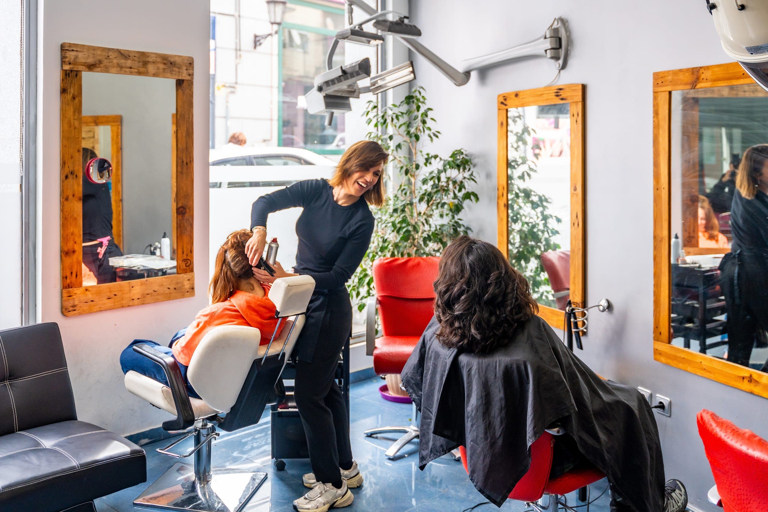 Cosmetologist cutting hair in a salon