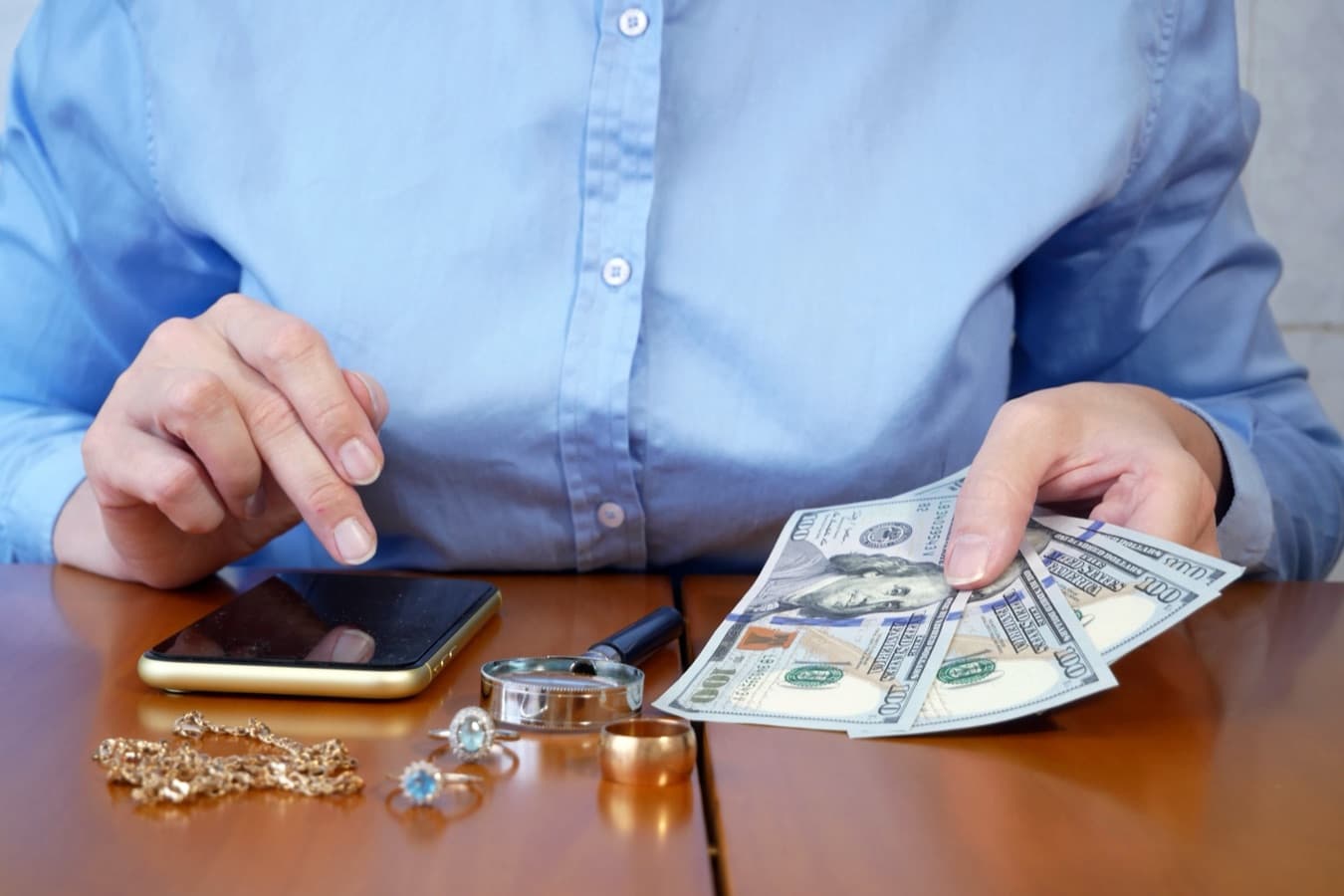 Pawn shop employee processing a customer payment