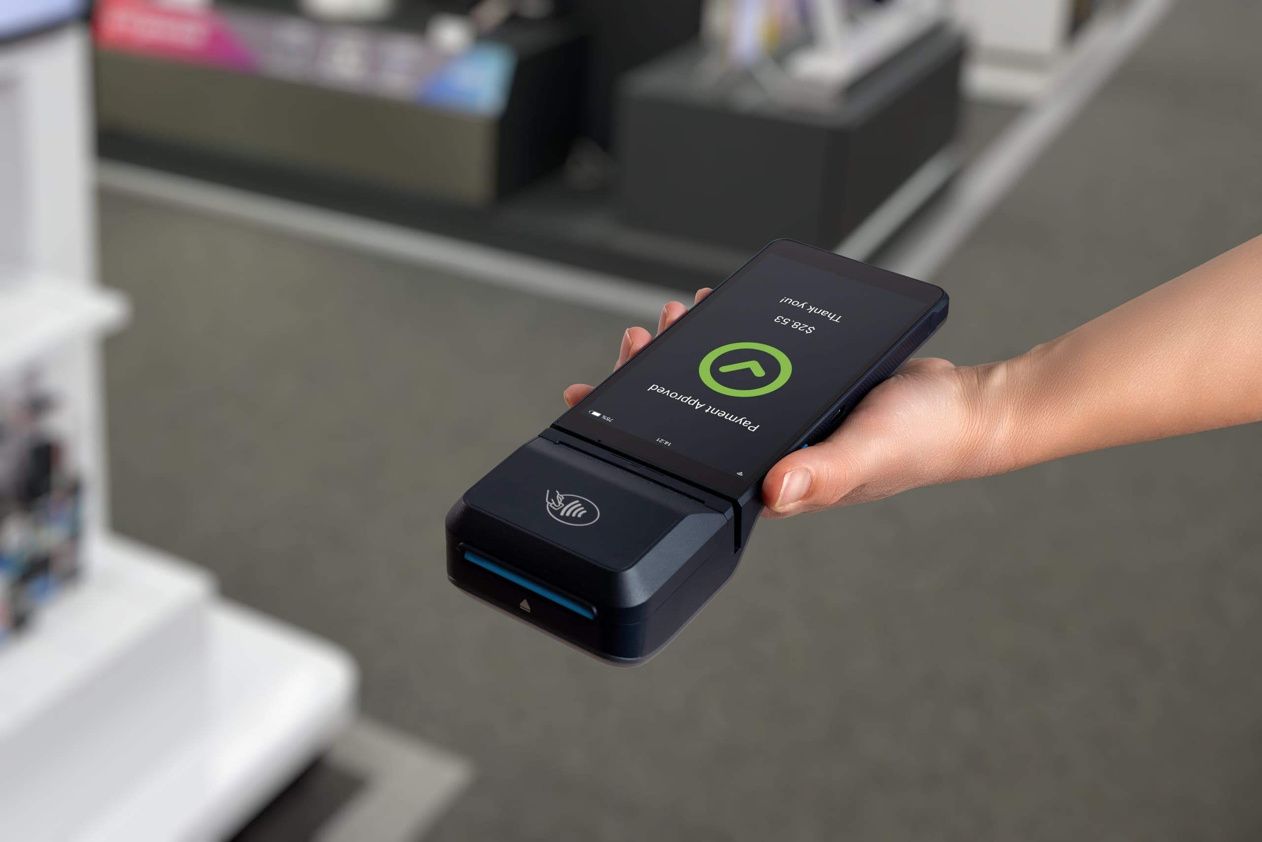 Mobile card reader showing an approved transaction processed through a secure payment gateway
