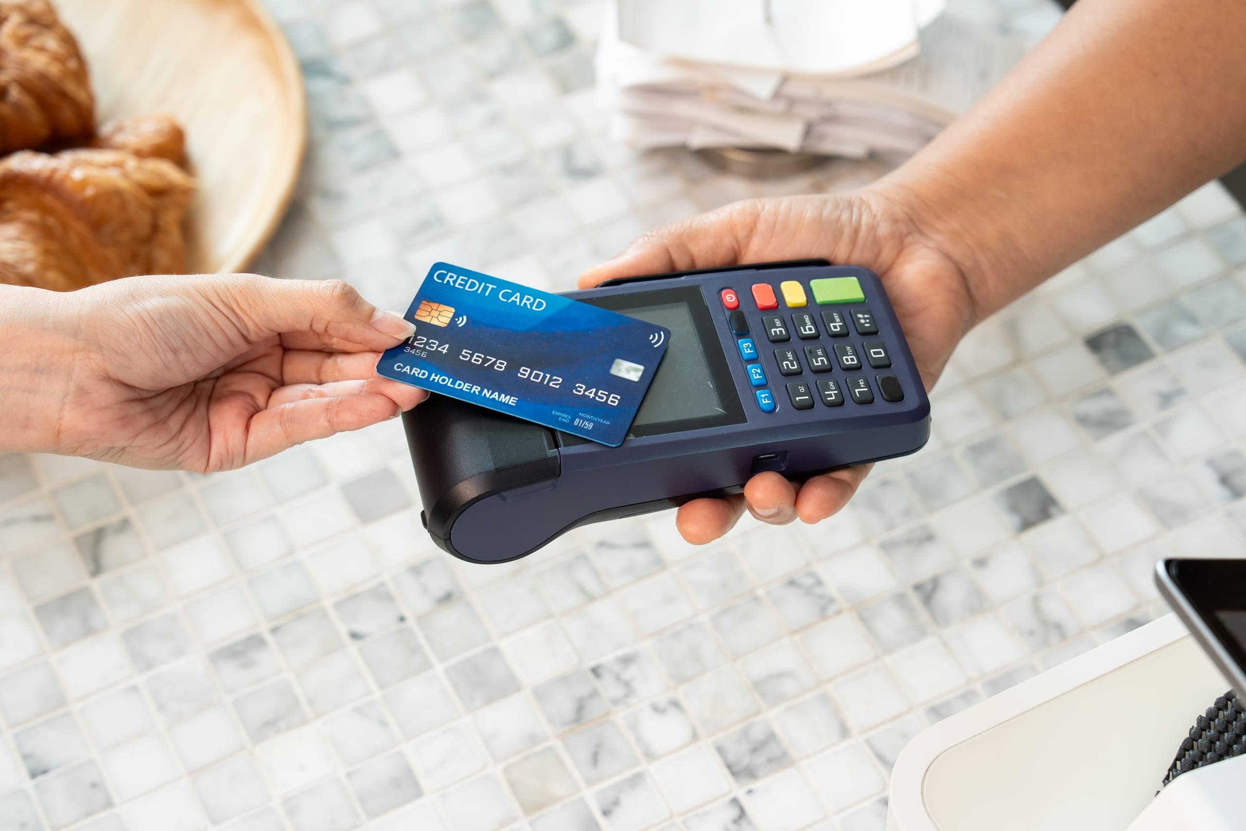 Customer using tap to pay on a PCI-compliant high-risk POS terminal