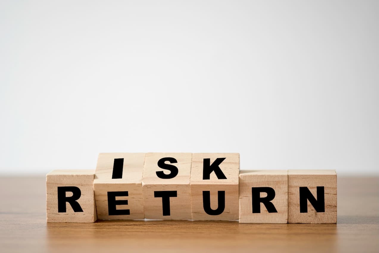 Wooden blocks spelling risk and return, representing high risk merchant accounts